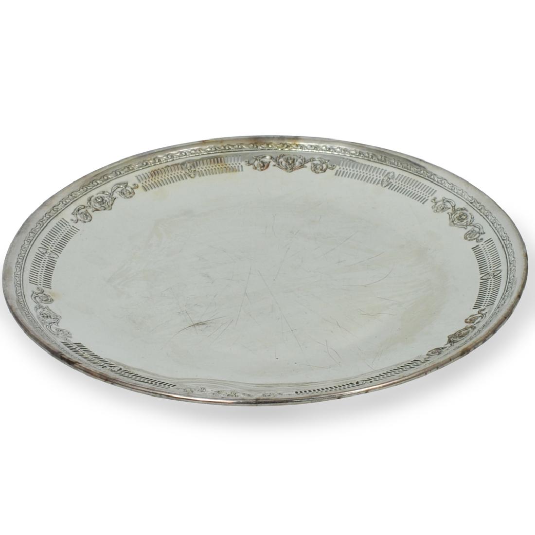Large Sterling Silver Round Tray: DESCRIPTION: A large sterling silver round tray. Features a floral border with reticulated edges. No apparent markings. Total weight: 852 grams. CIRCA: 20th Century DIMENSIONS: D. 15" CONDITION: Good