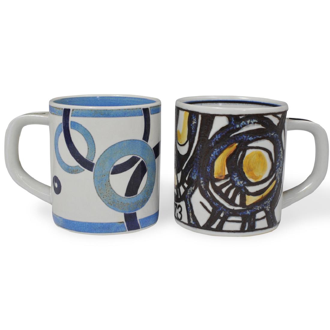 (2 Pc) Royal Copenhagen Faience Mugs: DESCRIPTION: Two Royal Copenhagen faience mugs. Including a 1972 annuel mug designed by Bodil Buch , and a 1973 annual mug designed by Gerd Hiort Petersen. Marked on the underside. Note: Annually ever