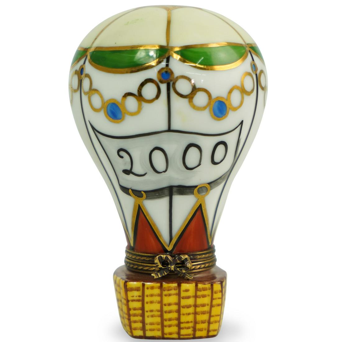 Limoges Hot Air Balloon Trinket Box: DESCRIPTION: A Limoges hand painted porcelain trinket box in the shape of a hot air balloon, finished with gilded ribbon form clasp. Marked on the underside: "Peint Main Limoges France La Gloriette" C
