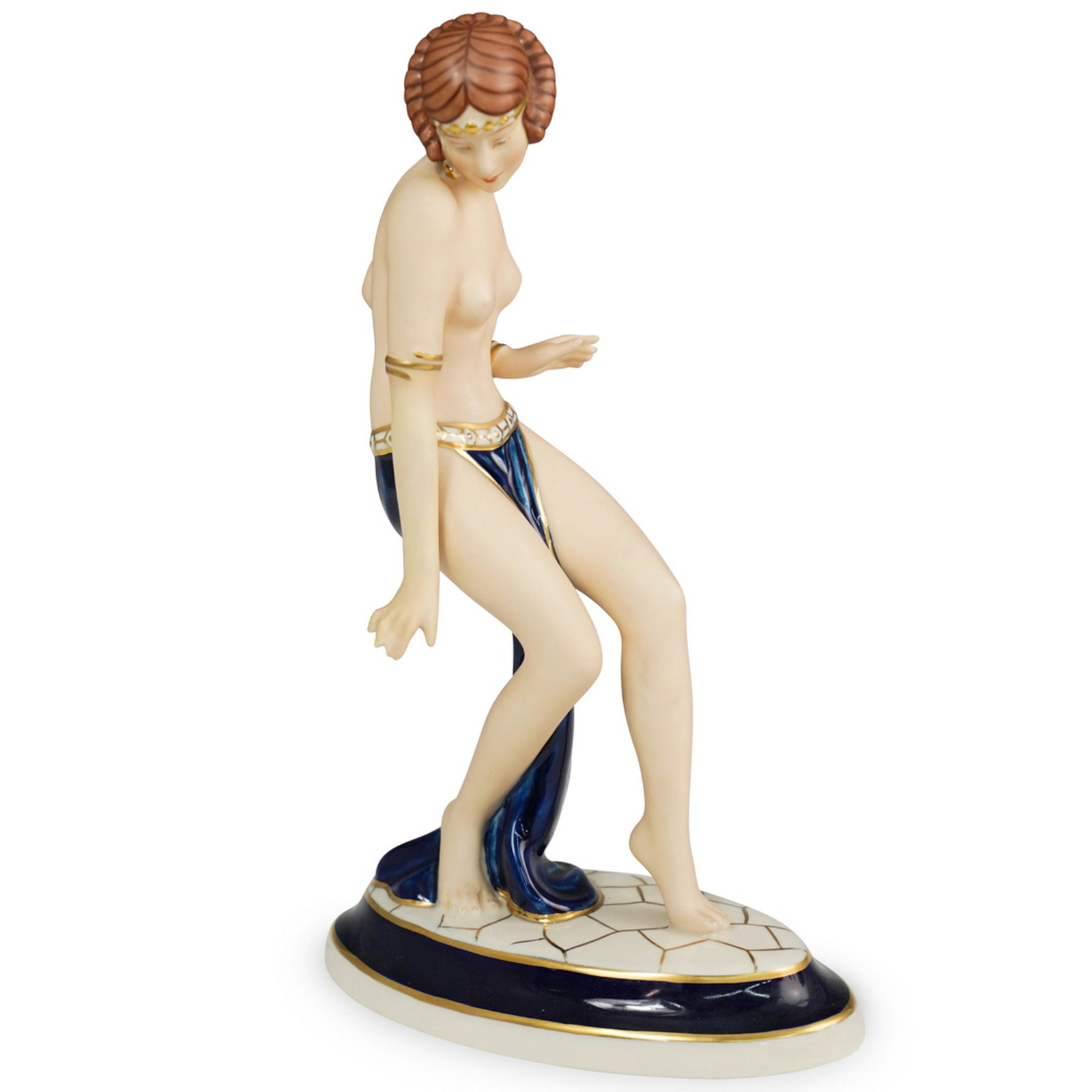 Royal Dux Art Deco Figurine: DESCRIPTION: A Royal Dux porcelain figurine. Depicting a semi-nude dancer in a cobalt skirt with gilded borders. Stamped on the underside. CIRCA: Early 20th Century ORIGIN: Czechoslovakia DIMENSIONS: 