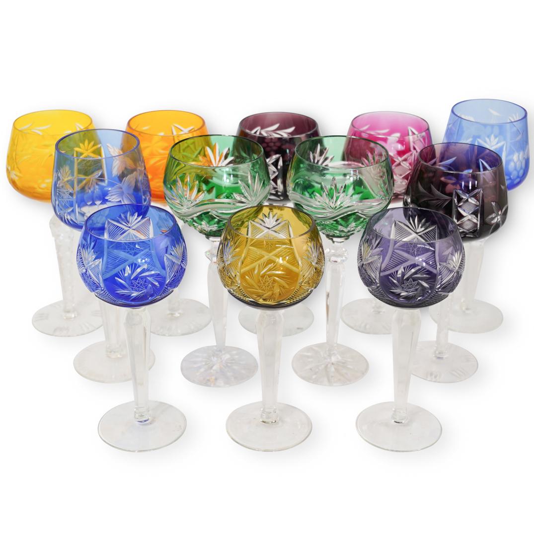 (12 Pc) Bohemian Cut Clear Crystal Wine Glasses: DESCRIPTION: A Set of 12 multi-colored bohemian cut to clear crystal wine glasses. Each depicts hobstar and starburst motif cuts on the crystal. No apparent markings. CIRCA: 20th Century ORIGIN: Possi