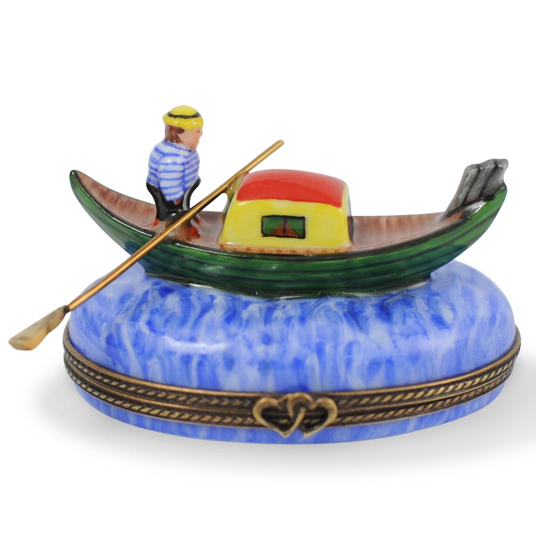 La Gloriette Limoges Porcelain Trinket Box: DESCRIPTION: A La Gloriette Limoges porcelain trinket box. Features a painted figure on a gondola, having a gilt metal lining and double heart clasp handle. Marked along the underside: "Peint Main Lim