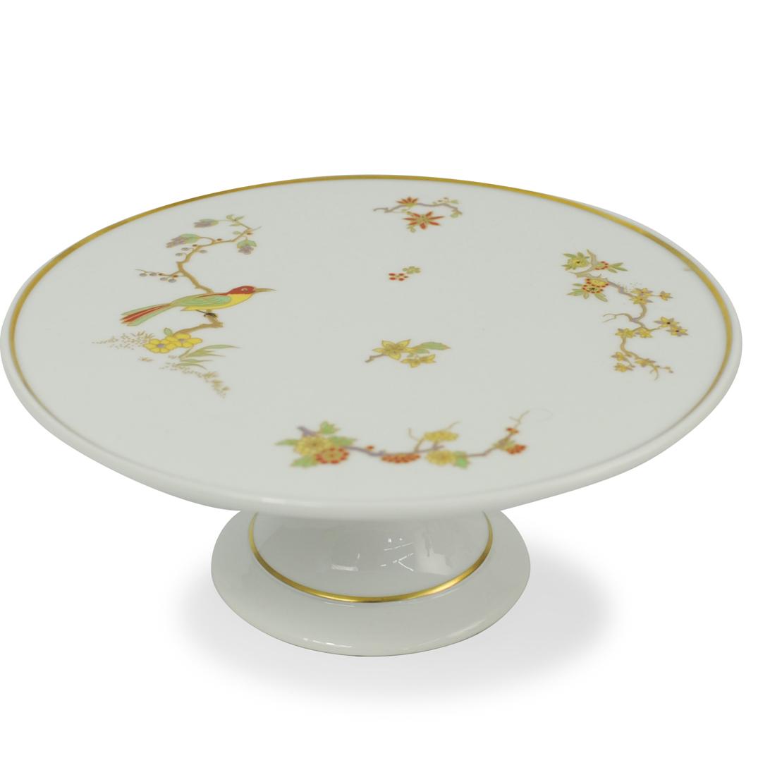 Richard Ginori Porcelain Cake Stand: DESCRIPTION: A Richard Ginori porcelain cake stand. Features a fluted base and stem supporting the top plate. Garnished with Oriental floral motifs and birds perched atop branches. Finished with gilde