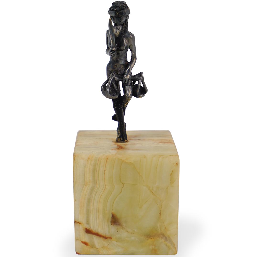 Miniature Metal Sculpture on Onyx Base: DESCRIPTION: A miniature painted metal sculpture depicting a blindfolded girl holding a sword in one hand and a justice scale on the other hand, mounted on a onyx base. CIRCA: 20th Century ORIGIN: Con