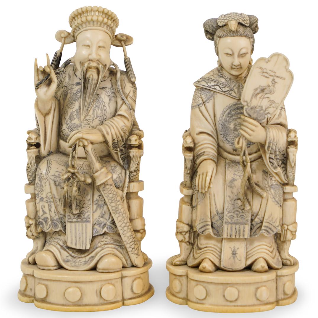 Signed Chinese Carved Bone Emperor and Empress: DESCRIPTION: a pair of Chinese carved bone figurines depict an Emperor and Empress, each figure is finely carved sitting atop a throne and embellished with black ink decorations. Marked along the unde