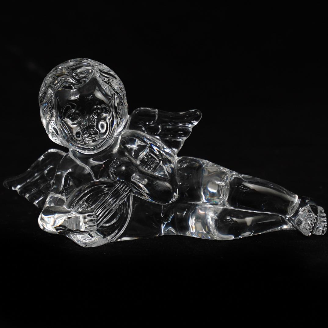 Waterford Crystal Angel: DESCRIPTION: A Waterford crystal angel, depicted in a reclined position playing a musical instrument. Signed on the foot. CIRCA: 20th Century ORIGIN: Ireland DIMENSIONS: H. 3.5" x W. 6.25" CONDITION: 