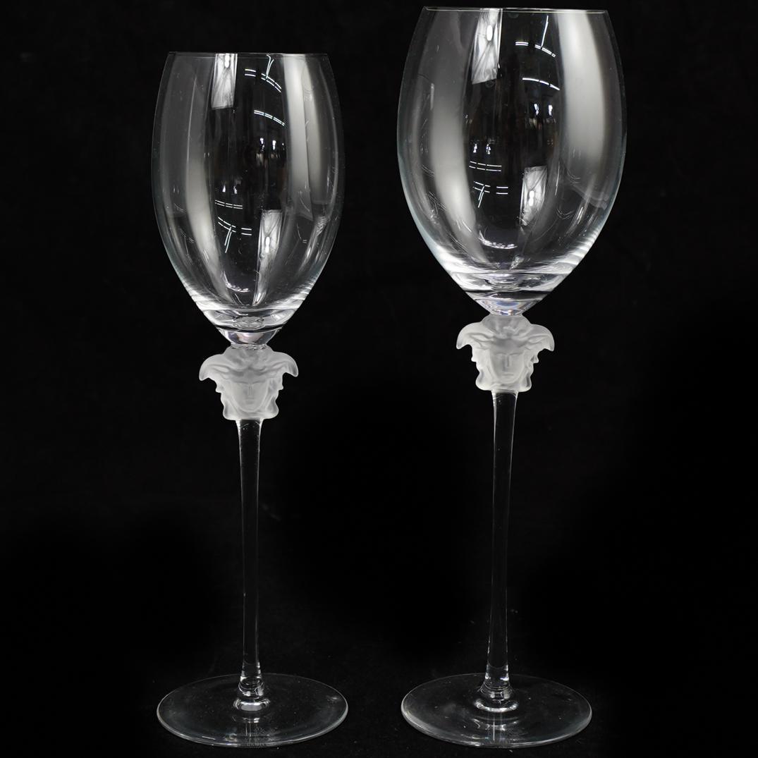 Two Rosenthal Versace Lumiere Wine Glasses: DESCRIPTION: A lot of 2 Rosenthal Versace 'Lumiere' wine glasses, comprising of one red wine glass and one white wine glasses. Crafted from hand blown and shaped glass. Decorated with the face of Medu