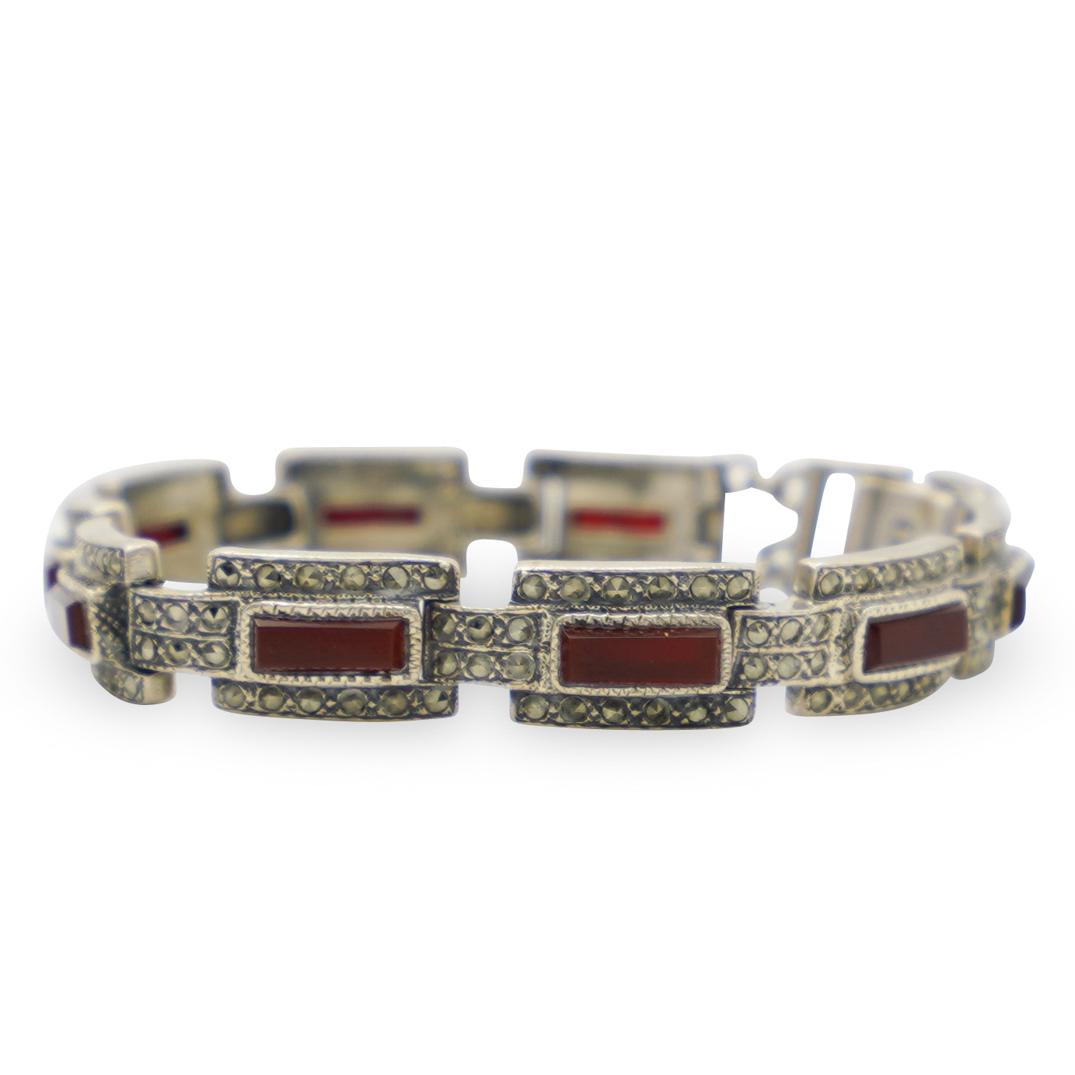 Vintage Sterling and Carnelian Bracelet: DESCRIPTION: A vintage bracelet composed of a sterling silver foundation features 9 links fitted with rectangular cut Carnilians. Marked "925", Total Weight: 30 Grams CIRCA: 1960s-1970s ORIGIN: Contin