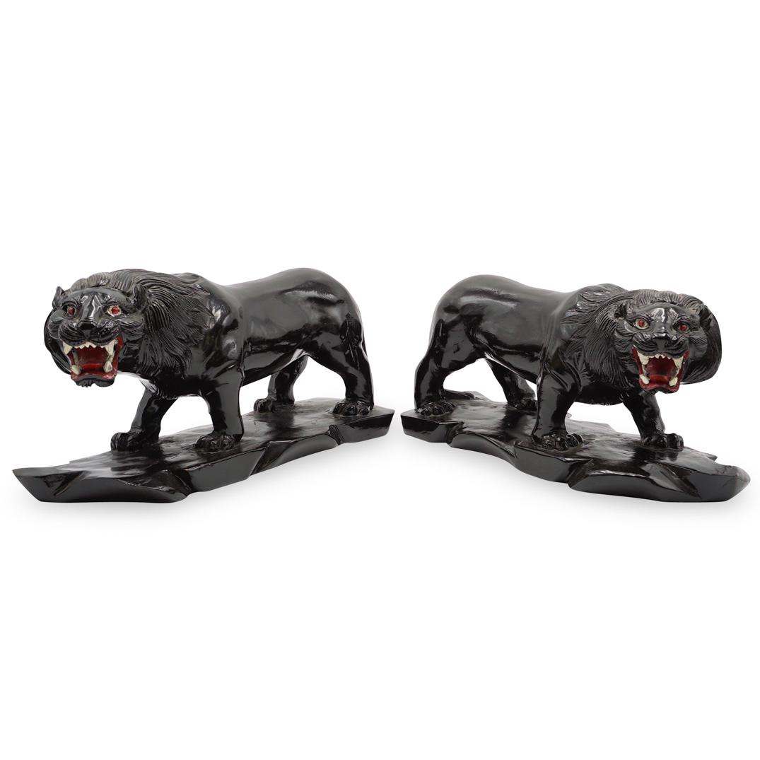 Vintage Ebonized Lion Sculptures: DESCRIPTION: A pair of vintage hand carved lion sculptures comprised of ebonized wood with red polychrome accents. CIRCA: 1950s ORIGIN: France DIMENSIONS: H: 7.5" W: 14.75" Depth: 5.25" CONDITION: Gre