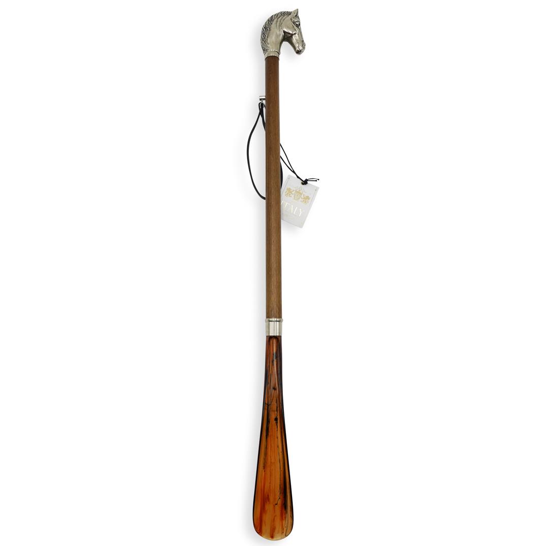Vintage Italian Shoe Horn: DESCRIPTION: A vintage Italian shoe horn composed of a wooden rod topped by a silver toned metal horse head handle and a bakelite shoe horn along the bottom. Tagged:"Created in Italy". CIRCA: Mid-Late