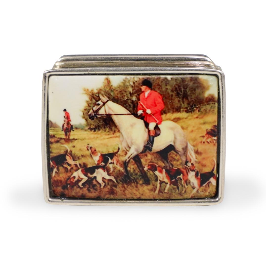 Sterling Silver and Enamel Pill Box: DESCRIPTION: A Sterling silver and enamel pill box. Features a gentleman on horseback with hound dogs. Marked "Sterling". Weight: 20.3 grams. CIRCA: 20th Century ORIGIN: Continental DIMENSIONS: L. 1.2
