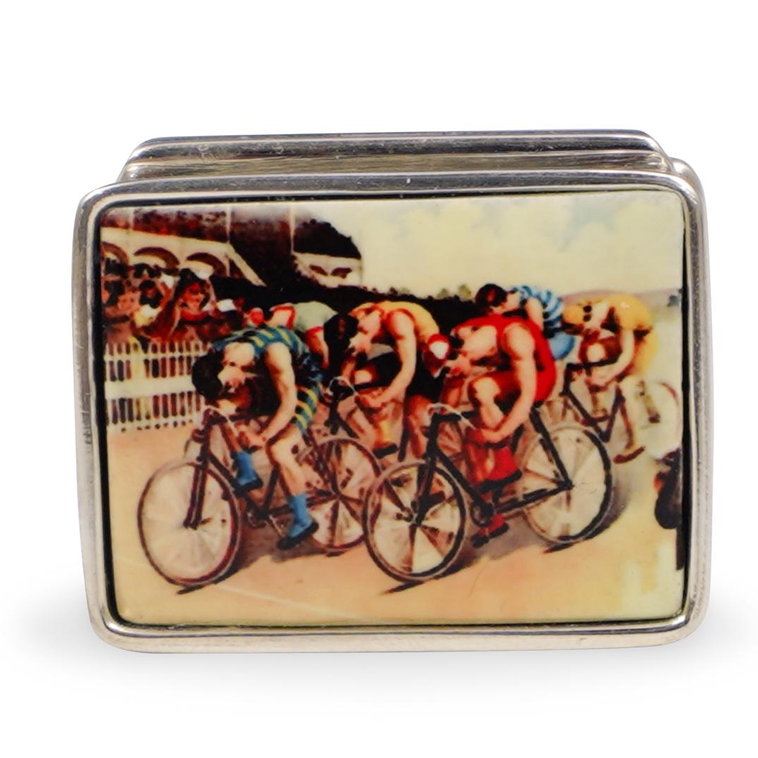 Sterling Silver and Enamel Pill Box: DESCRIPTION: A Sterling silver and enamel pill box. Featuring cyclist in a race. Marked "Sterling". Weight: 20.4 grams. CIRCA: 20th Century ORIGIN: Continental DIMENSIONS: L. 1.25" CONDITION: Great co