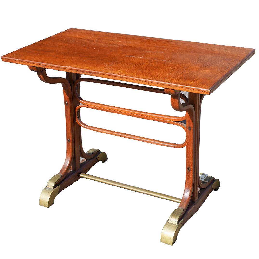Jacob And Josef Kohn Writers Desk: DESCRIPTION: A writers desk composed of Mahogany wood, supported by a curved bridge center, and completed with brass finishes along the legs. Singed underneath the table top, signature is being blocke