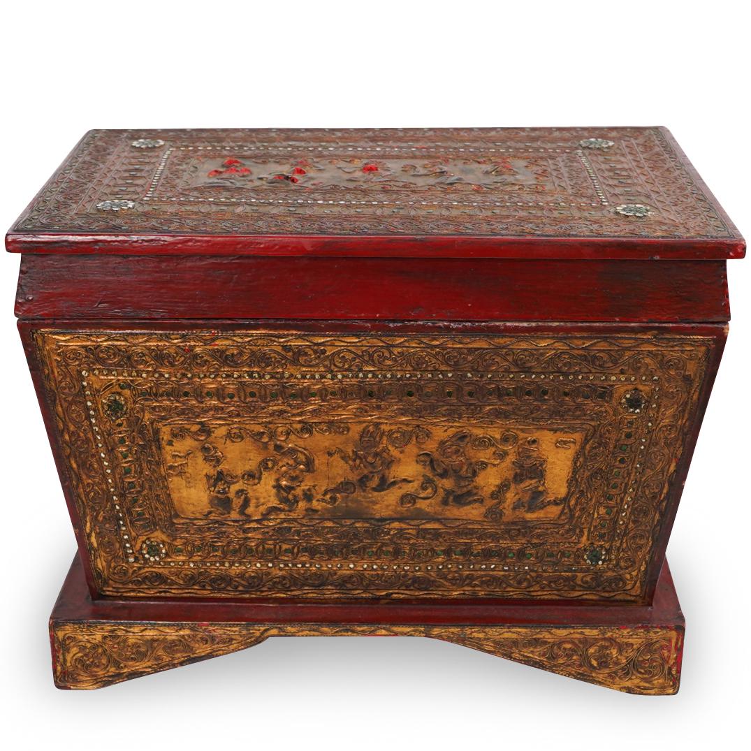Thai Jeweled Covered Lacquer Box: DESCRIPTION: An antique lacquer and gilt wood carved box with jeweled accents and figures in relief. CIRCA: Early - Mid 20th Century ORIGIN: Thailand/China DIMENSIONS: H. 15" x W. 20". D. 12.5" CONDIT