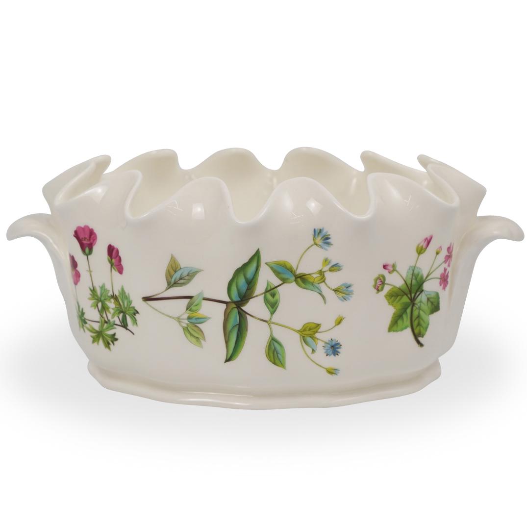 Minton Bone China Jardiniere: DESCRIPTION: A Minton's bone china floral jardiniere with scalloped edge and leaf form handles. Stamped on the underside. CIRCA: 20th Century ORIGIN: England DIMENSIONS: H. 4.5" x W. 10" CONDITION: Gr