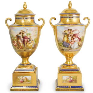 Pair of Royal Vienna Porcelain Urns: DESCRIPTION: A pair of Royal Vienna Porcelain covered urns, features a gold ground with cobalt blue accents and figural portrait with women in landscape, signed with Royal Vienna hallmark. CIRCA: 20th