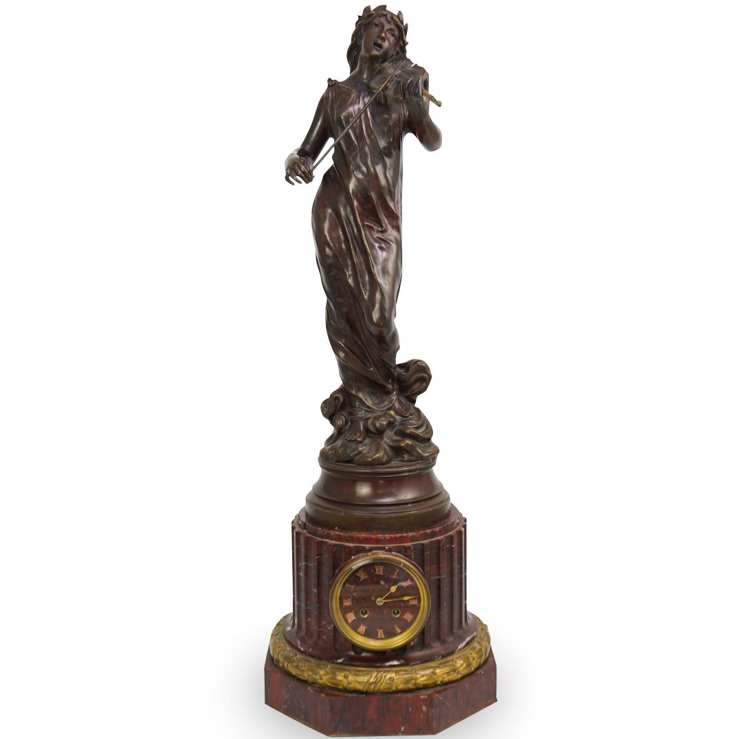 Jean Garnier (French 1853-1910) Lefbreve and Fils: DESCRIPTION: Bronze and Marble Figural Clock, Depicting a Classical maiden playing a violin, set upon a gilt bronze mounted red marble columnar base set with a clock, the bronze signed "J. GARNIER," w