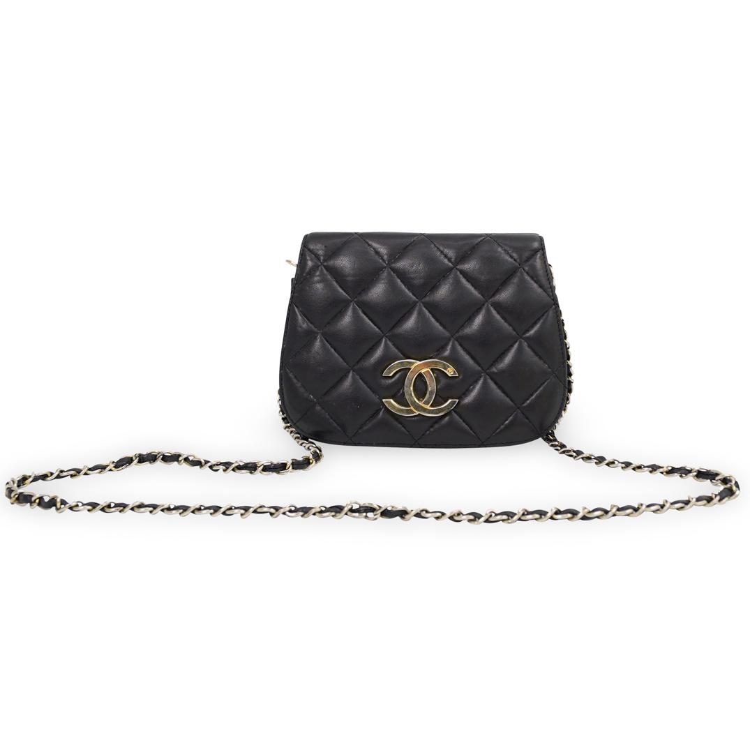 Vintage Chanel Black Leather Purse: DESCRIPTION: A Vintage Chanel double flap purse, features one side quilted leather and one side grain leather with brass double 'C' logo, each side opens to reveal compartment with zipper pocket. Labe
