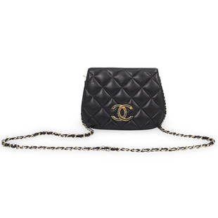 Vintage Chanel Black Leather Purse: DESCRIPTION: A Vintage Chanel double flap purse, features one side quilted leather and one side grain leather with brass double 'C' logo, each side opens to reveal compartment with zipper pocket.