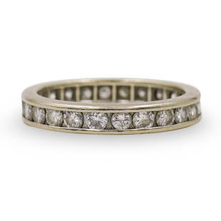 18k Gold and Diamond Wedding Band: DESCRIPTION: A 18k white gold ring decorated along the center with approx. .03 ct round cut diamonds amounting to a total of .69 ct. Total Weight: 2.4 dwtCIRCA: 20th Cent.ORIGIN: USADIMENSIONS: Ring