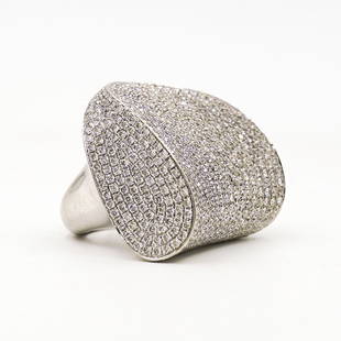 Large 18k Gold and Pave Diamond Ring: DESCRIPTION: A Large 18k White gold ring, featuring in an abstract design, embellished with approximately 13.5 cts in white diamonds. Marked "750" Total weight of ring: 30.8 Grams (19.8 dwt) CIRCA: 20