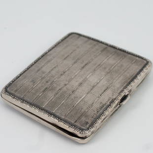 Antique German Silver Compact: DESCRIPTION: An antique German .830 silver compact case. Features a textured, striped design, enveloped by scrolled floral motif. Monogramed on interior "J.K. Welhn 35." Finished with an interior