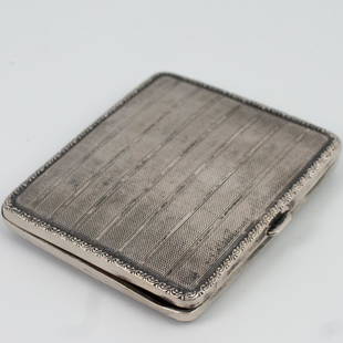 Antique German Silver Compact: DESCRIPTION: An antique German .830 silver compact case. Features a textured, striped design, enveloped by scrolled floral motif. Monogramed on interior "J.K. Welhn 35." Finished with an interior verm