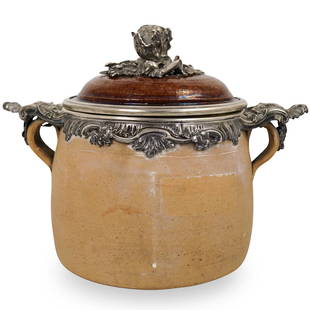 Terracotta Container with Silver Mounts: DESCRIPTION: A terracotta container with silver mounted cover, rim and handle. Features raw terracotta body with glazed cover and silver handle decorated with rose finial. No apparent markings.CIRCA:
