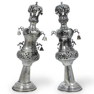 Pair of Judaic Sterling Silver Torah Crowns: DESCRIPTION: A Pair of Sterling silver torah crowns. With openwork crowns and two central balusters on stepped bases, engraved and repousse decorative scroll and floral decoration, having attached