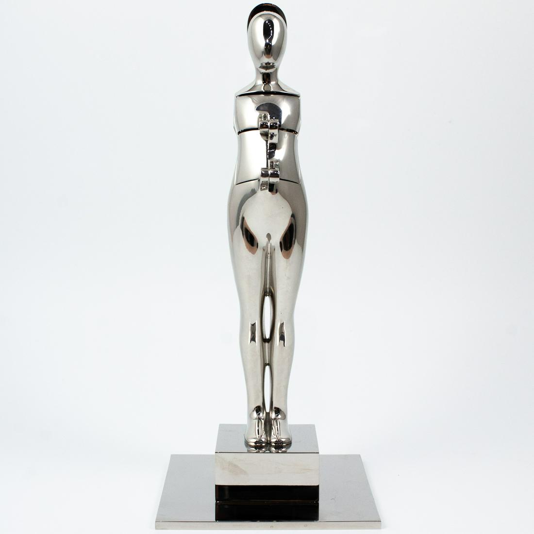 Ernest Trova (American, 1927-2007) "Flap Man": DESCRIPTION: A sculpture by American surrealist artist Ernest Trova features a stainless steel figure titled "Flap Man" crafted with mechanical appendages. The torso, back, and face swing open by hing