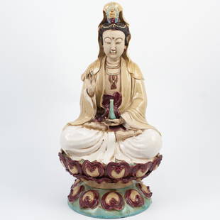 Chinese Guan Yin Porcelain Figurine: DESCRIPTION: A Quan Yin porcelain figurine. Features a hand painted porcelain figurine of a goddess wearing mandala necklace and holding a vase containing the waters of compassion, seated on a lotus