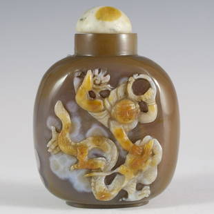 Chinese Agate Snuff Bottle: DESCRIPTION:Agate snuff bottle embellished with raised illustration of a man soaring through the sky grabbing a fierce dragon.Ã‚ CIRCA:Early 20th Ct.Ã‚ ORIGIN:ChinaÃ‚ DIMENSIONS:H:3.5"