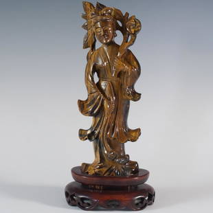 Tigers Eye Guanyin Figurine: A hand carved and polished statue made of Tiger's Eye, a crystal that is believed to aid in harmony and balance, depicting Guanyin, a prominent figure in Chinese Buddhism who is the deity of mercy,