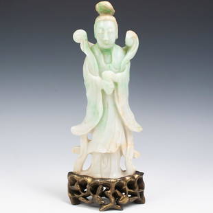 Chinese Jadeite Carved Guanyin Figurine: DESCRIPTION: A large 19th century Chinese carved Guanyin figurine composed of jadeite ranging from white, vibrant green and light brown hues. The figure stands fully robed with vines draping across