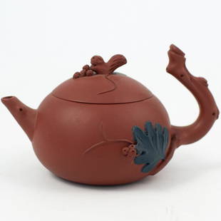 Chinese Yixing Clay Teapot: DESCRIPTION: Chinese Yixing clay handle teapots. Teapots from Yixing, China, in a reddish hue, with branch handle and applied leaf motif. Stamped Underneath CIRCA:Ã‚ ORIGIN: China DIMENSIONS: H. 3"