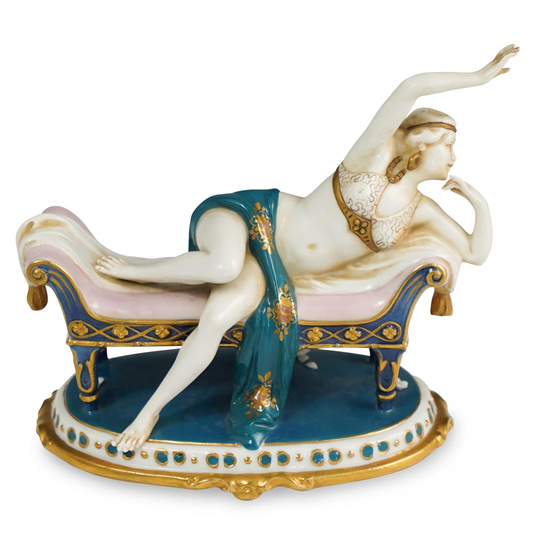 Goebel Art Deco Figurine: DESCRIPTION: A Goebel German Porcelain Art Deco Figurine. Depicts a gypsy dancer laying on a classical sofa. Stamped on underside. CIRCA:1930s ORIGIN: Germany DIMENSIONS: H. 6.5" x W. 7" x D. 4.25" CO