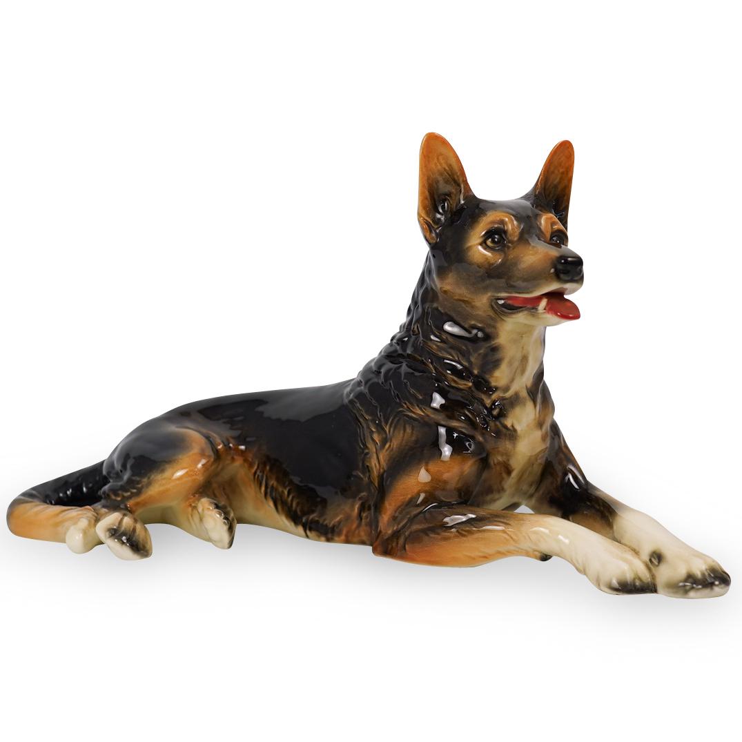 Goebel Porcelain German Shepard: DESCRIPTION: A Goebel hand painted porcelain German Shepard. Labeled on the underside. CIRCA: 20th Century ORIGIN: Germany DIMENSIONS: H. 8" x W. 17" CONDITION: Great condition. See lot description fo