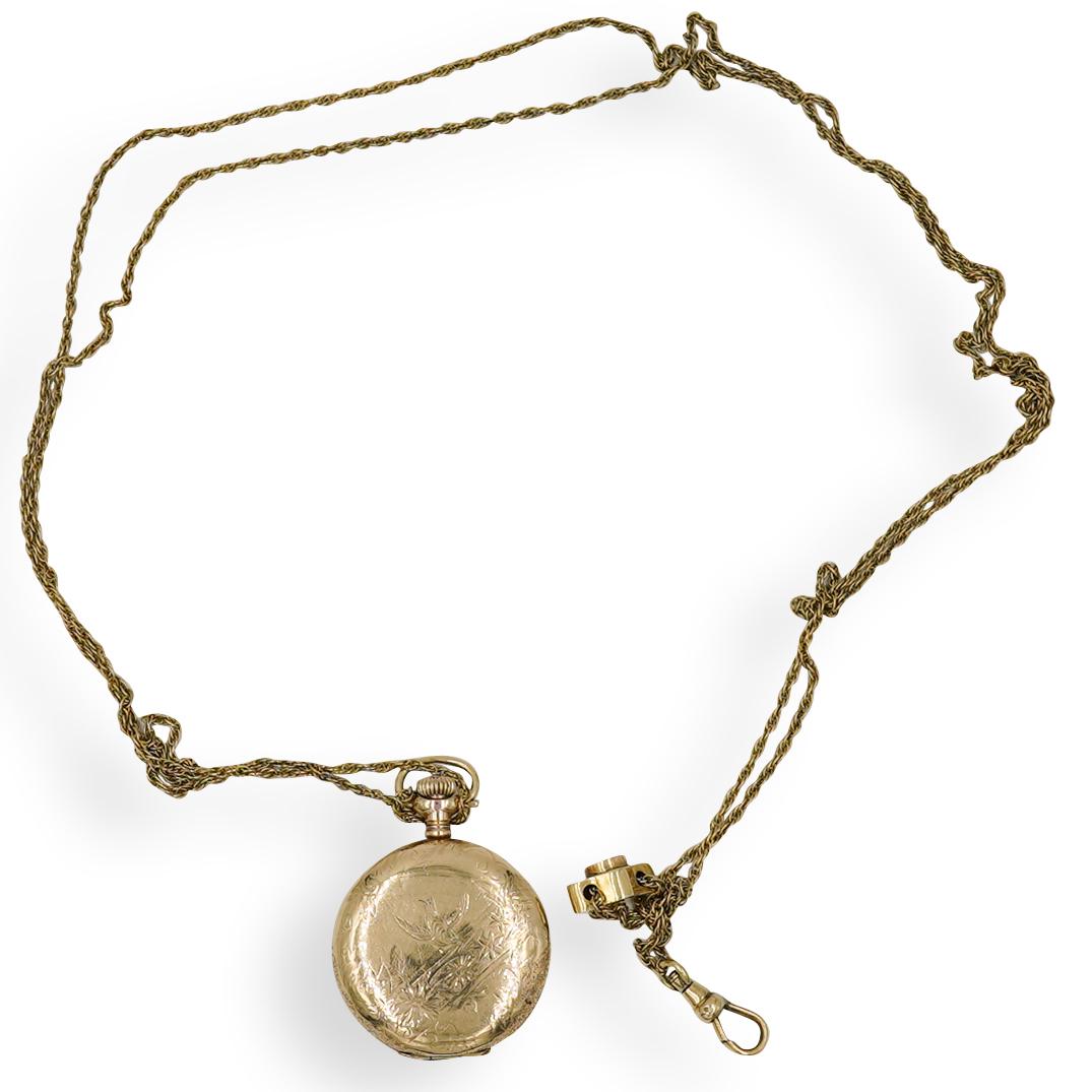 Waltham Gold Filled Pocket Watch & Chain: DESCRIPTION: Waltham gold filled pocket watch, featuring engraved foliate design on the front and reverse, with chain. Needs replacement battery. CIRCA: 20th Century ORIGIN: USA DIMENSIONS: Watch L. 1