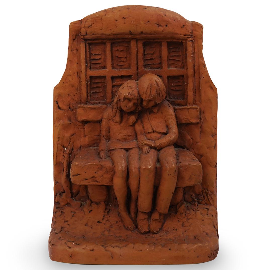 J. Comley Signed Wall Mounted Sculpture: DESCRIPTION: Signed J. Comley & stamped JC. on side handcrafted clay sculpture of a couple sitting on a bench. Hardware attached on back for wall mounting.Ã‚ Ã‚ CIRCA: 20th CenturyÃ‚ ORIGIN: