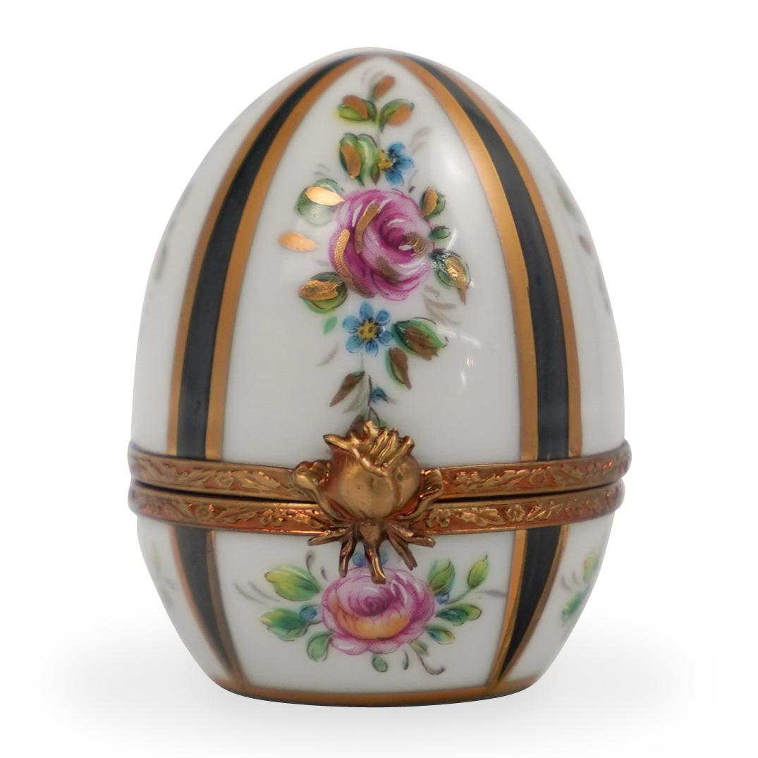 Limoges Porcelain Pill Box: DESCRIPTION: A Limoges Porcelain pill box. Features an ovoid form, garnished with floral motifs and gilded accents. Finished with a gilt metal lining and a floral motif clasp. Marked along the undersi