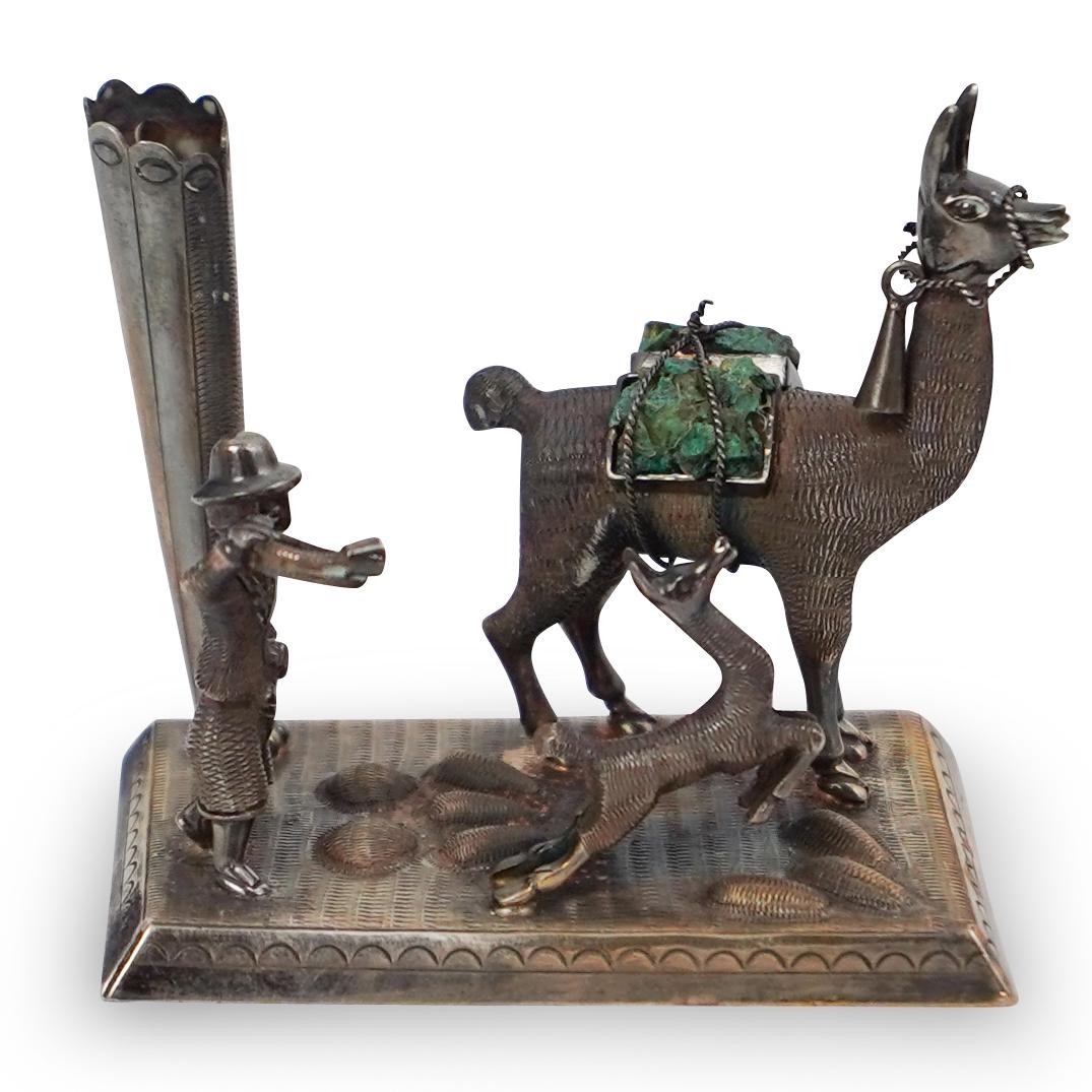 Sterling and Malachite Llama Figurine: DESCRIPTION: A small sterling silver Southwest scene with llama carrying a malachite stone on his back. Stamped "925" on the underside. Weight: 90 grams. CIRCA: 20th Century ORIGIN: Continental DIMENS
