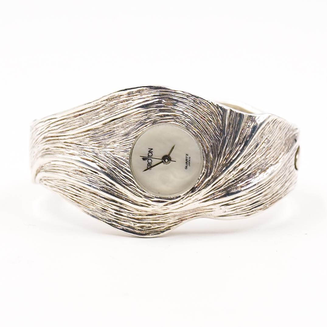 Croton Silver Ladies Watch: DESCRIPTION:A Croton sterling silver clasping womens watch with mother of pearl face In working condition. CIRCA:20th Ct. ORIGIN:Japan DIMENSIONS:L:2.25" CONDITION: Great condition. See lot descriptio