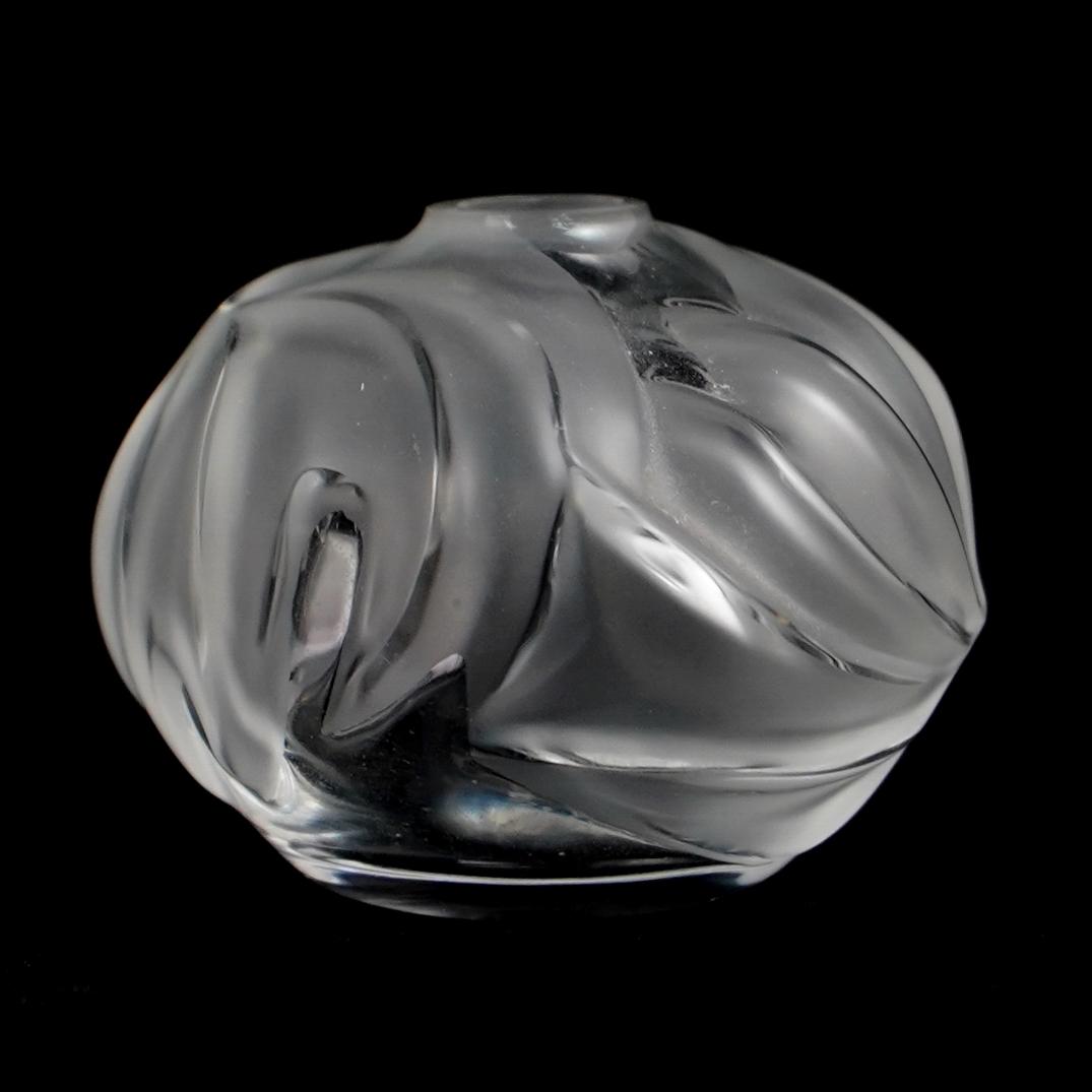 Lalique Perfume Bottle: DESCRIPTION: Lalique perfume bottle clear and frosted glass, missing stopper. Signed "Lalique" CIRCA: 20th Century ORIGIN: France DIMENSIONS: H. 2" x W. 2.5" CONDITION: Great condition. See lot descri