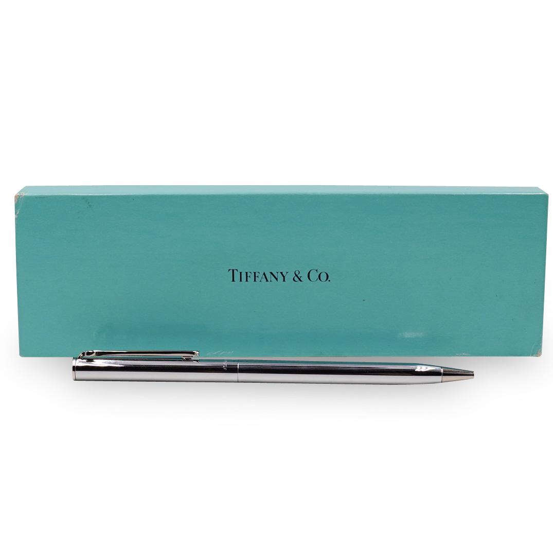 Tiffany & Co. Sterling Silver Pen: DESCRIPTION: A Tiffany & Co. sterling silver pen engraved "Box Hill (NYSE:BXH) Complete with Tiffany box and pen dust bag. CIRCA: 20th Ct. ORIGIN: USA DIMENSIONS: L:5 1/8" x W:10 mmÃ‚ CONDITION: Gr