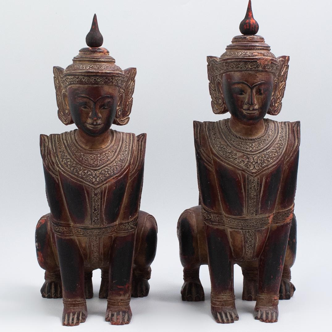 Pair of Shan Lacquered Wood Manok-Thi-Ha: DESCRIPTION: Pair of Shan lacquered wood temple guardian Manok-thi-ha. The lacquered wood sculptures of Manok-thi-ha, a double-bodied, human-headed lion, sits as a protector in a Shan Buddhist temple.