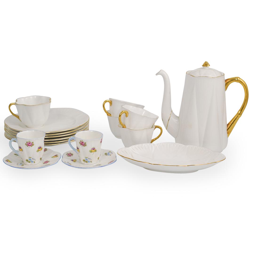 (18 Pc) Shelley Bone Porcelain Group: DESCRIPTION: A lot of 18 Shelley England bone china porcelain tea service. In the dainty white and gold trim pattern. Includes 6 plates and 6 tea cups and one tea kettle and dish. With two teacup and 