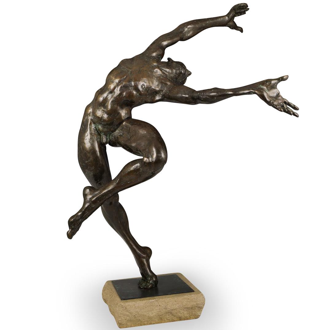 Roger Junk (American, 20th Century) Bronze Male: DESCRIPTION: A bronze male nude dancer depicted in an arabesque position mounted on a stone base. Signed and dated and numbered on foot, "RJ / 98 / 3/15". Roger Junk is primarily a sculptor, his work 