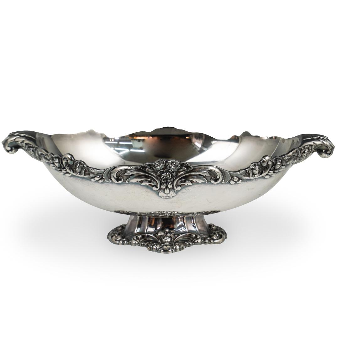 Silver Plated Lunt Centerpiece: DESCRIPTION: Silver Plated Lunt Centerpiece. Featuring floral engravings, flanked by two handles on each side. Stamped ''V75'' with original foil label. CIRCA: 20th Ct ORIGIN: USAÃ‚ DIMENSIONS: L:1