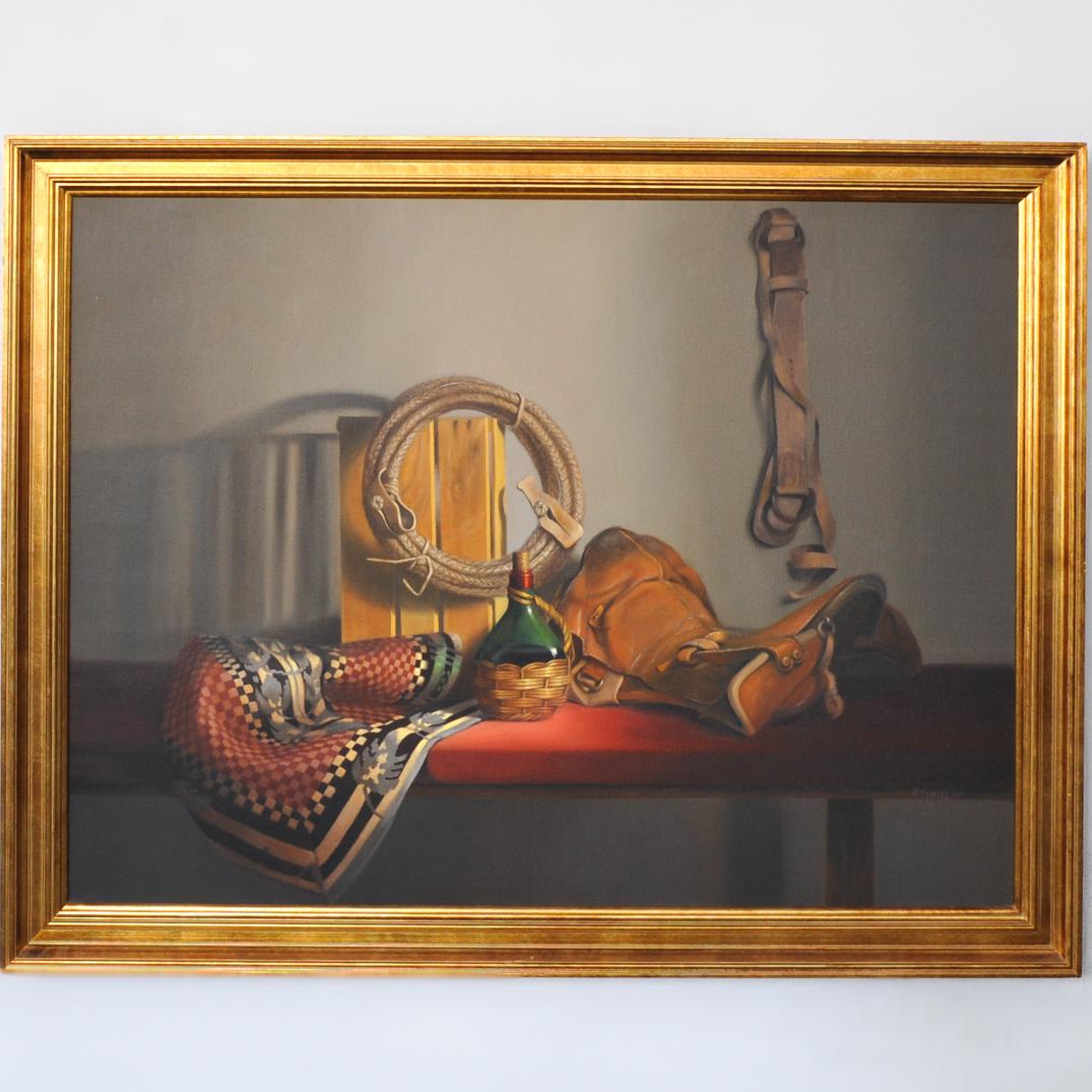 Alejandra Gauzen (Chilean, b. 1967) Oil on Canvas: DESCRIPTION: An oil on canvas still life painting by Alejandra Gauzen. Titled "Montura y Manta". Features a western theme still life composition with wine jug and holder, a leather saddle, rope, and s