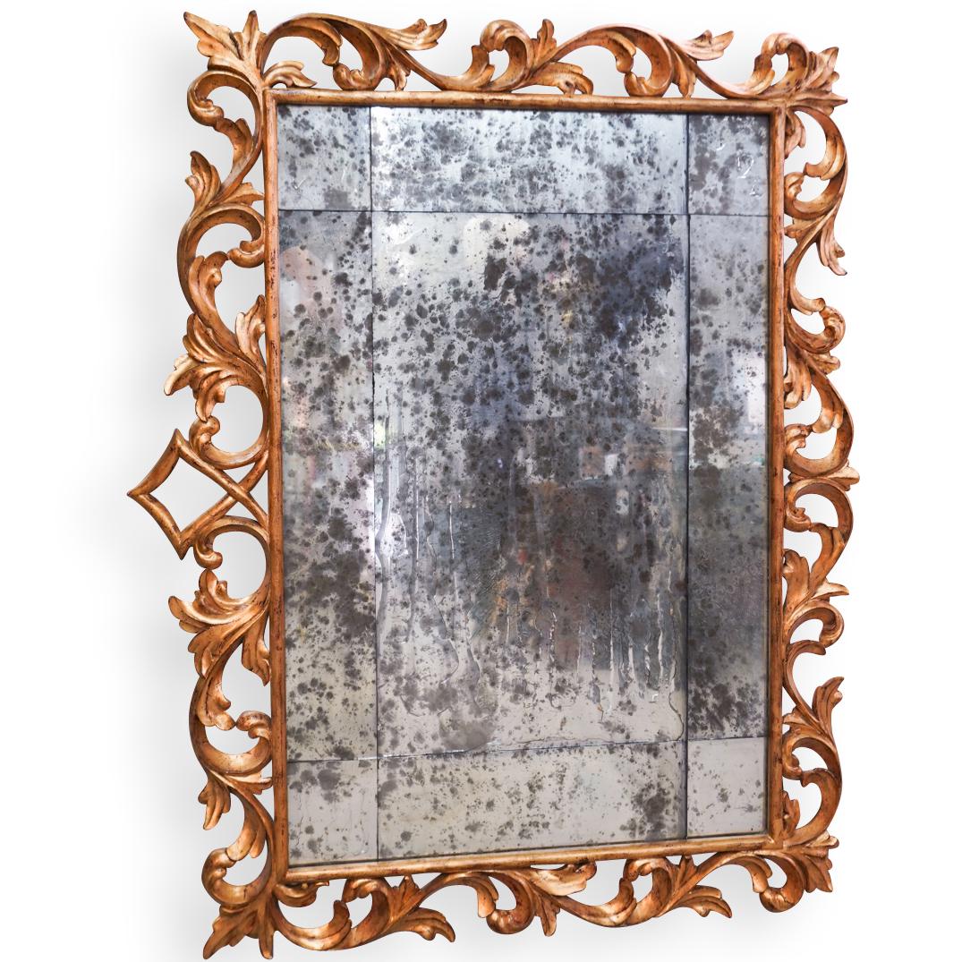 19th Cent. Giltwood and Mercury Mirror: DESCRIPTION: A 19th Cent. Giltwood framed mirror features carved openwork rococo patterns, centered by a mercury segmented mirror. The mirror has some distress due to age. CIRCA: Late 19th Cent. ORIGI